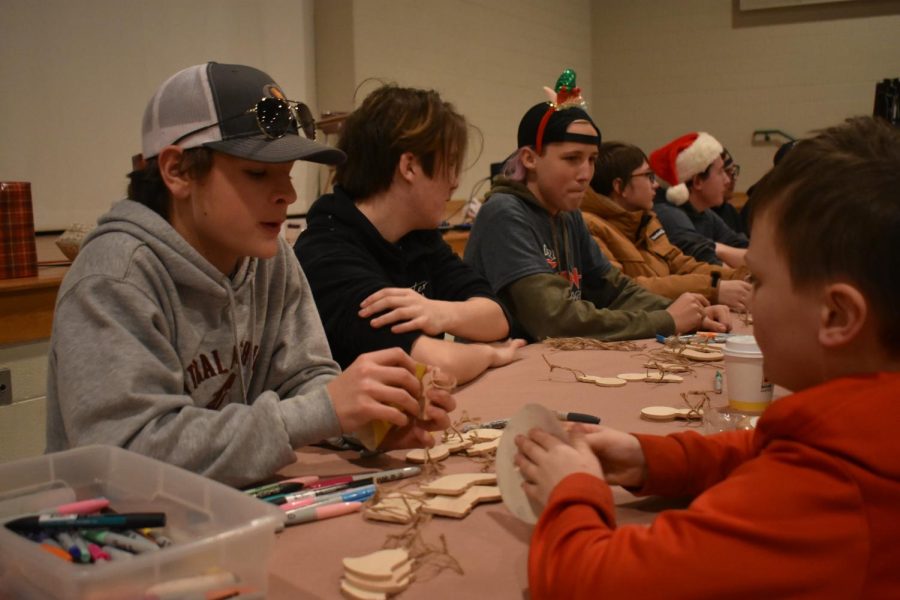 Woodshop members craft toys together.