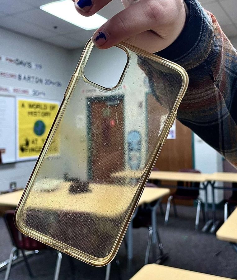 One student holds up a clear case in disgust at the color.