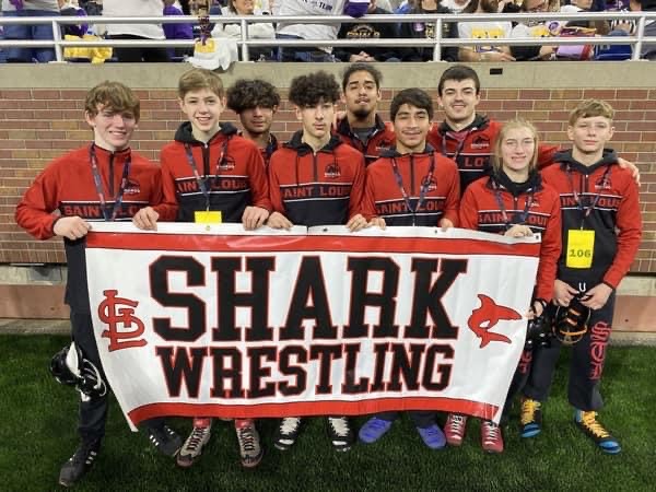 Individual wrestlers stand together before their big matches. 