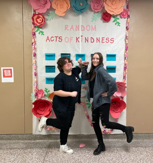 Juniors Carson Butcher and Myah Pitcher pose in front of their wall.