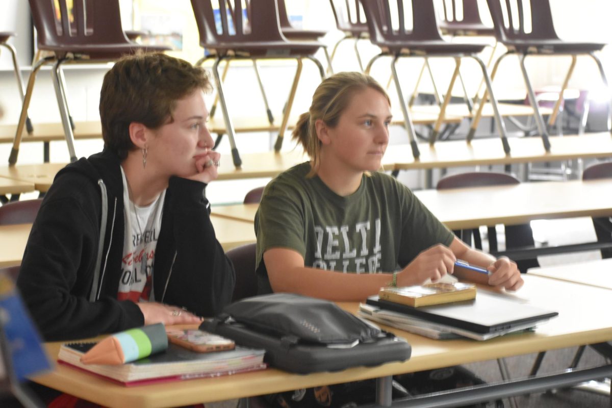 A couple of seniors, Claire Hubble and Lilly Massaway, analyze a film for the class.