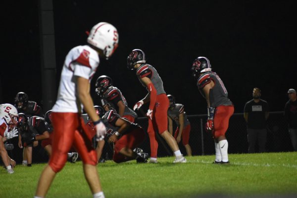 A Michigan Lutheran Seminary player lurks while the Sharks come up with a plan.