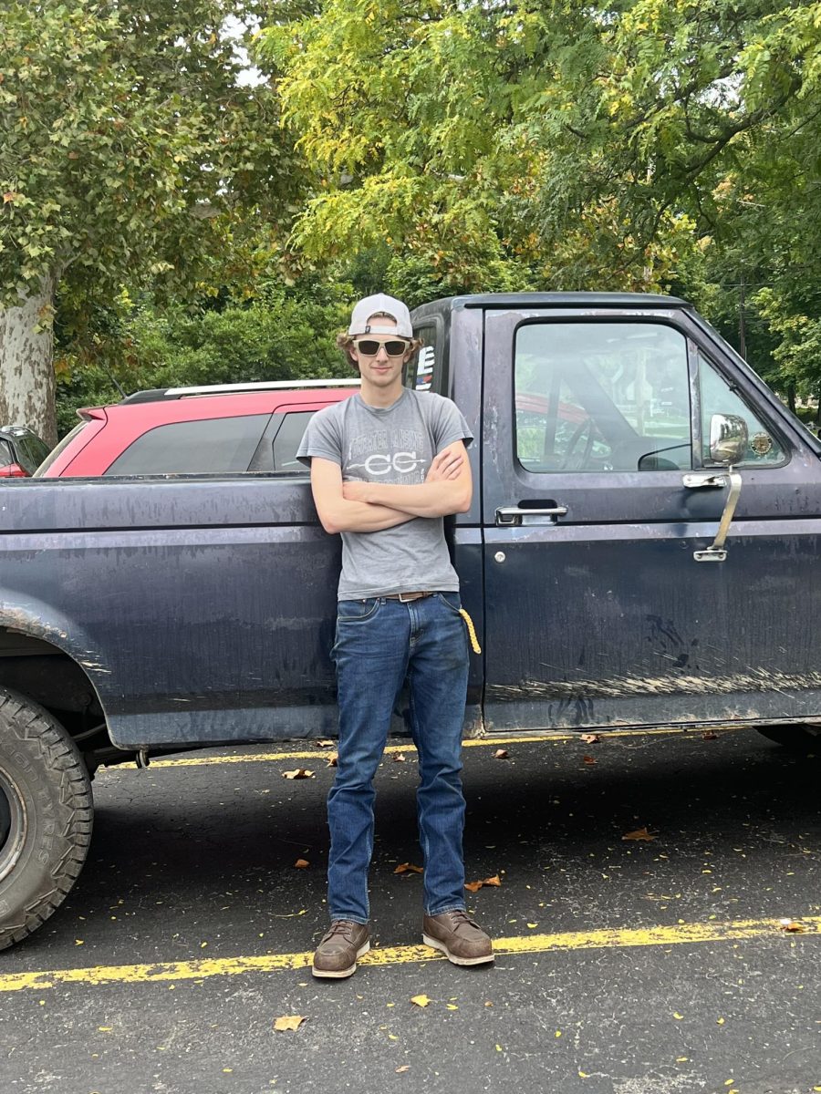 The burnout himself, senior Boone Childs, poses in front of his costly vehicle.
