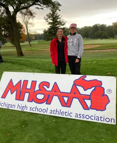 Golfer Natalee Hoyt stands beside her coach before the big day!