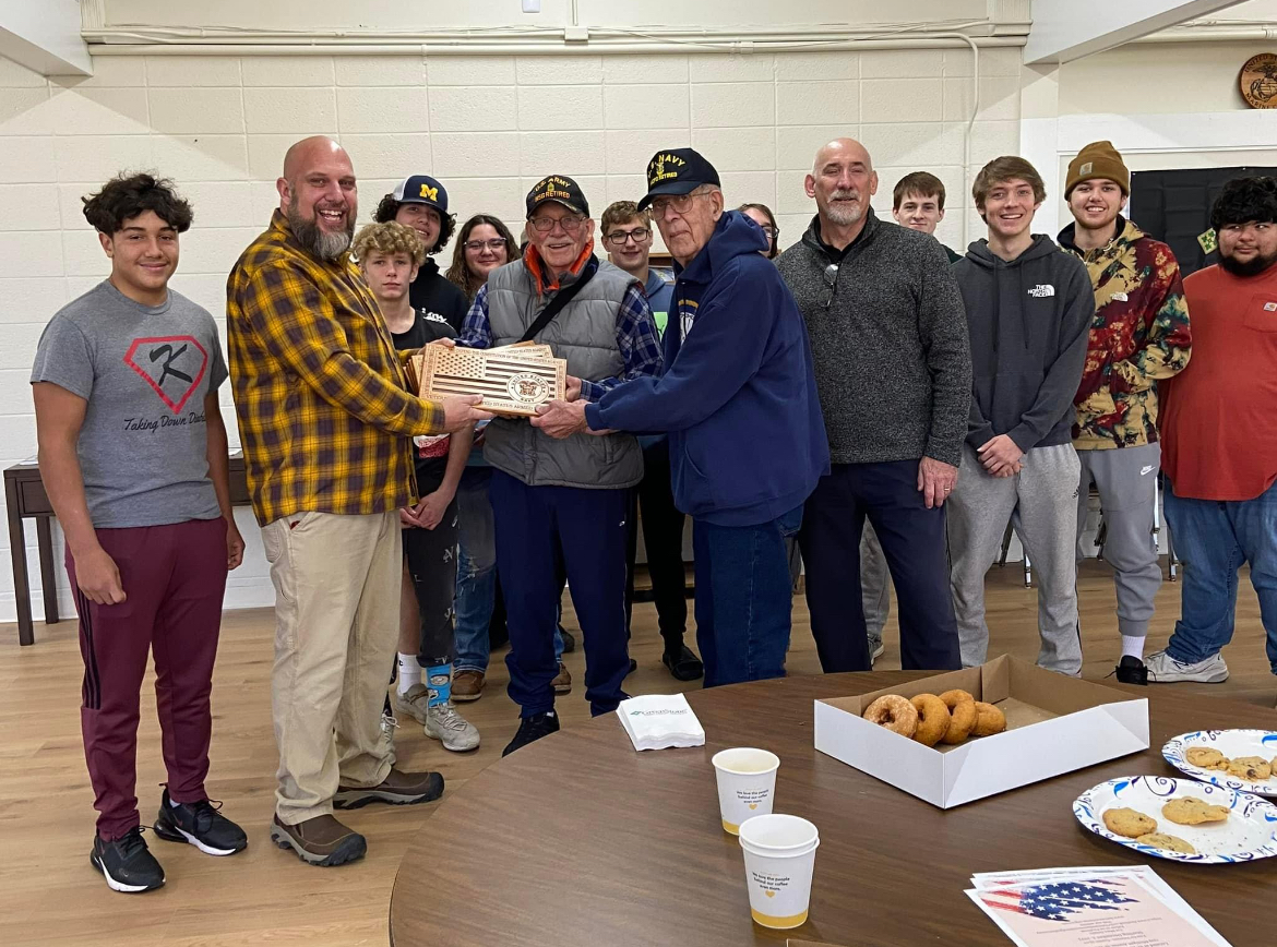 The Shark Tooth woodshop crew proudly presents the plaques to the veterans.