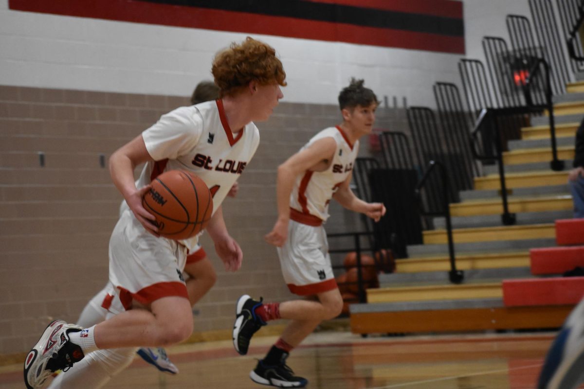 Racing down the court, Shark basketball players Noah Tripp and Landon Pestrue put in the work against the Yellowjackets.