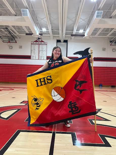 Senior Olivia Good poses with the well-deserved flag.