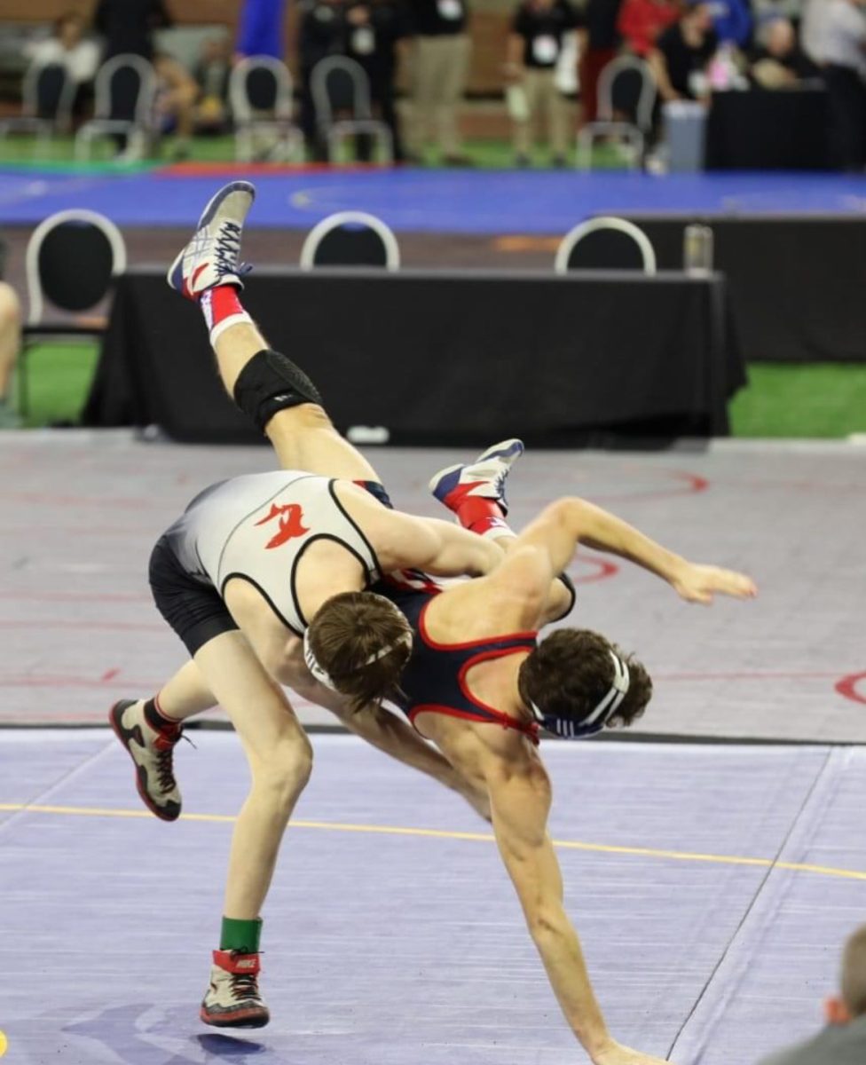 Junior wrestler Colin Kuhn slams his opponent down on the mat at Individual State Finals.