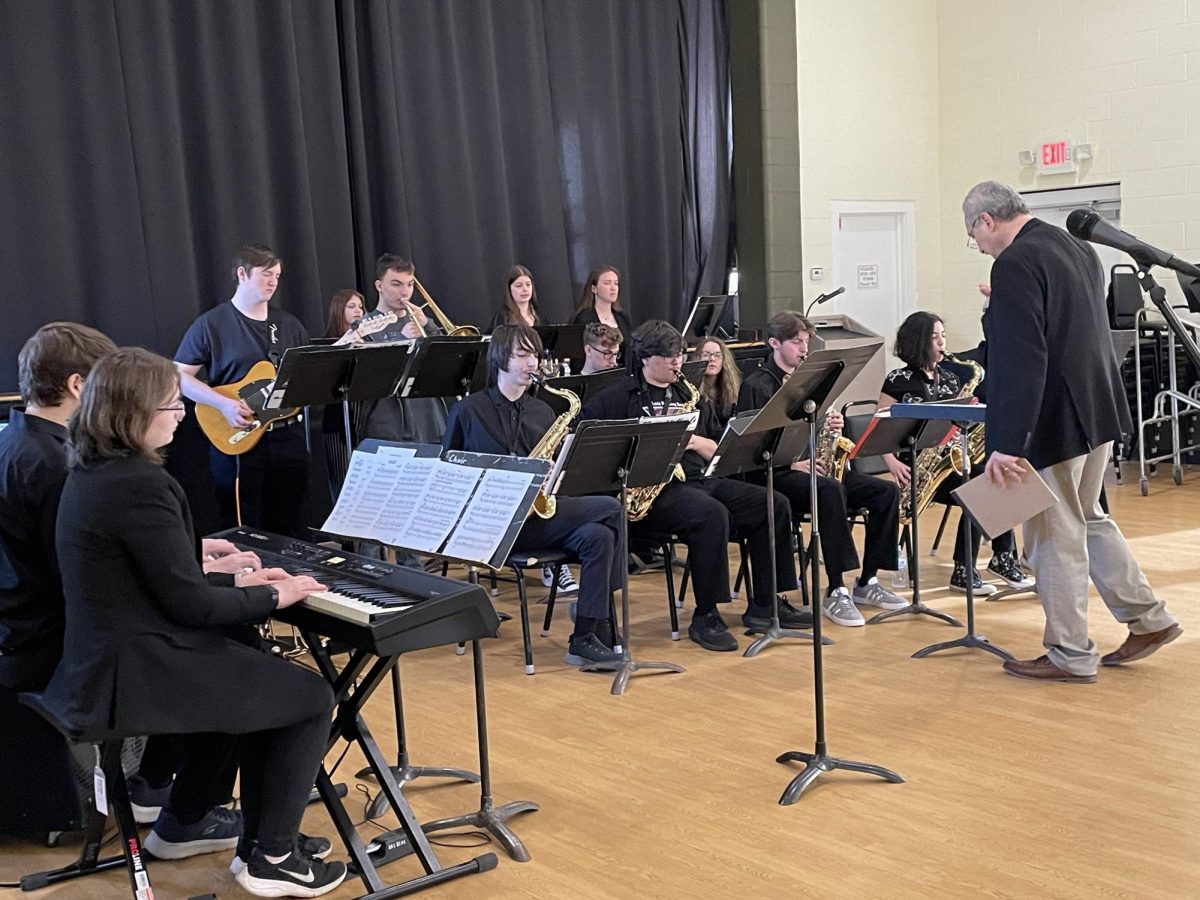 A clinician works with the jazz band, following their performance at Hastings!