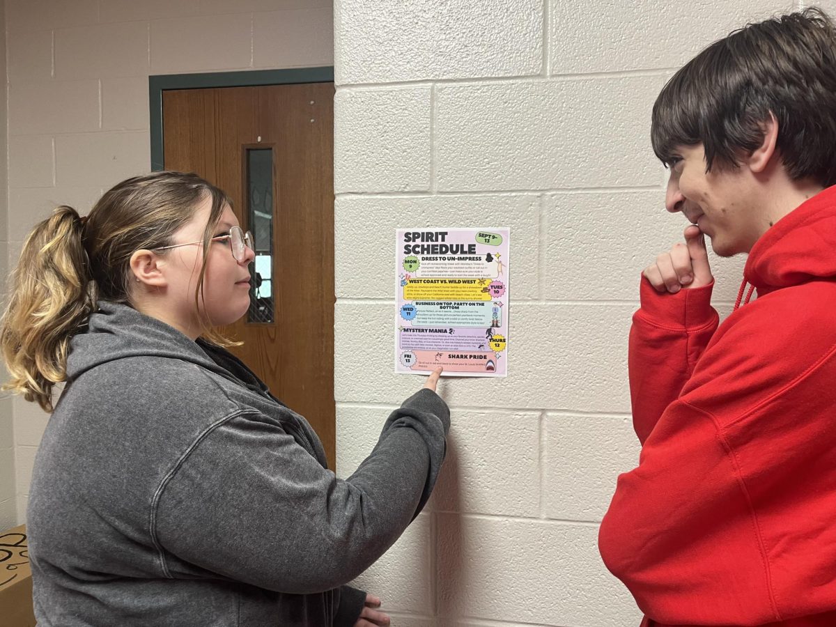 Two students take a look at the spirit schedule.