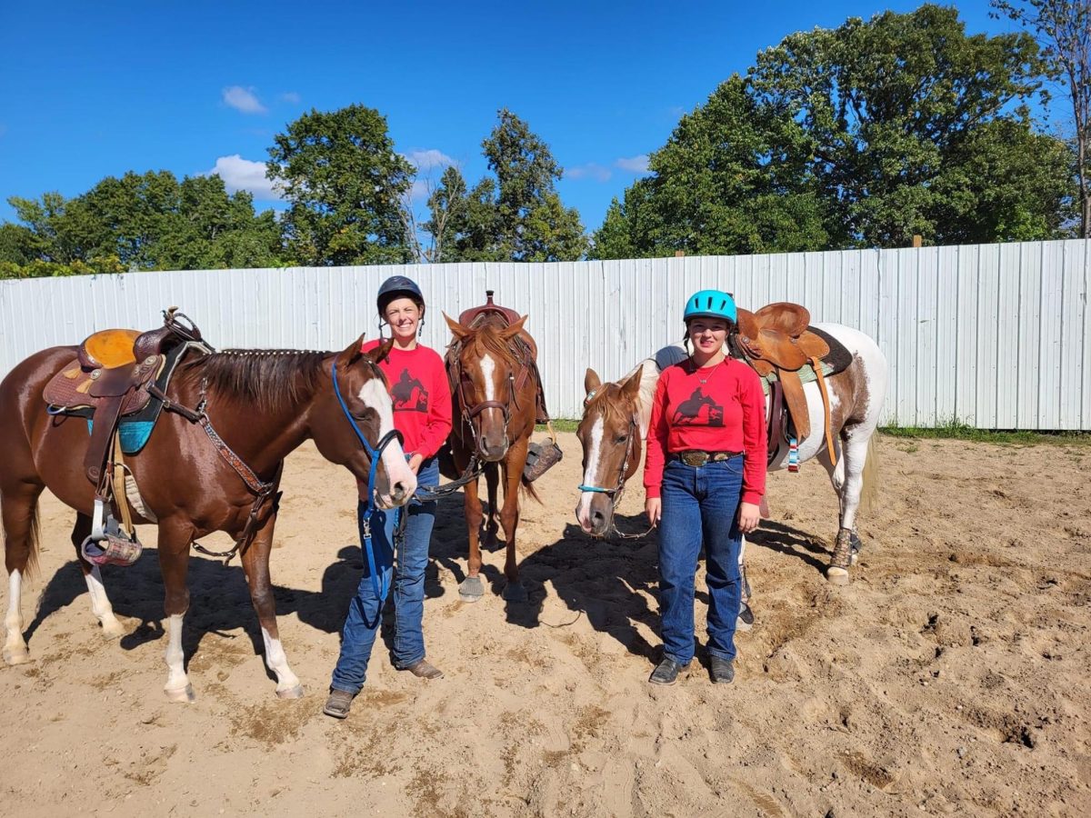 Seniors Bethany Bowerman and Rebekah Ross pose next to their horses.