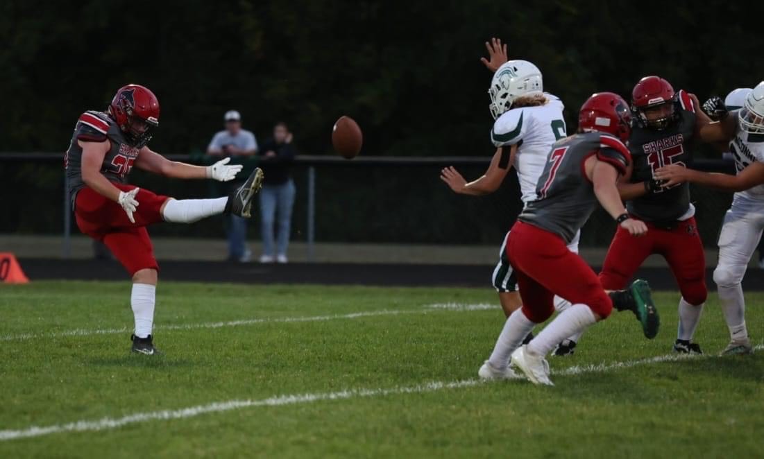 The Sharks fight hard to become victorious during the homecoming game.