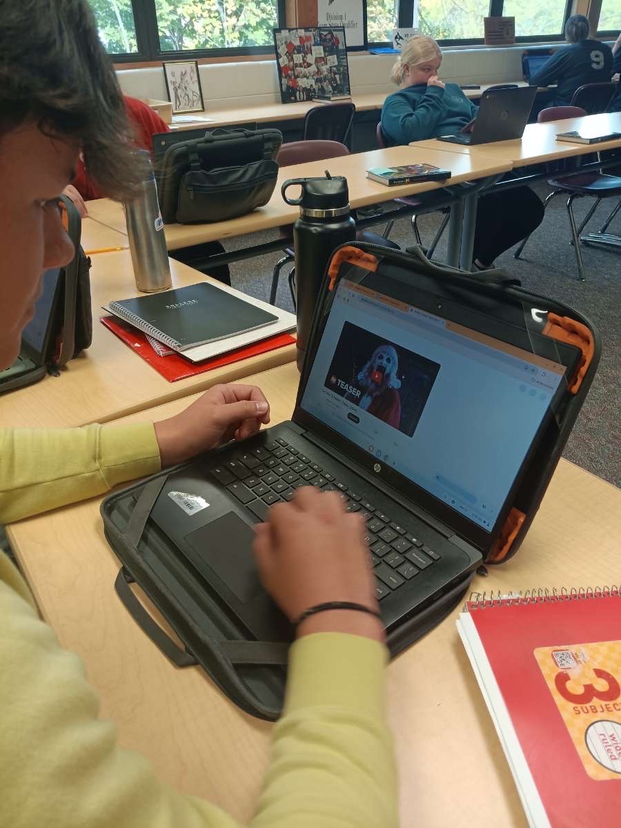 Senior Sawyer Wonch takes a look on his chromebook, previewing a teaser on a horror movie.