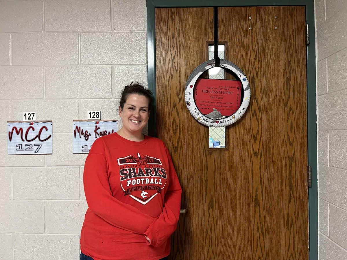 Mrs. Kaiser poses next to her Tireless Effort Award!