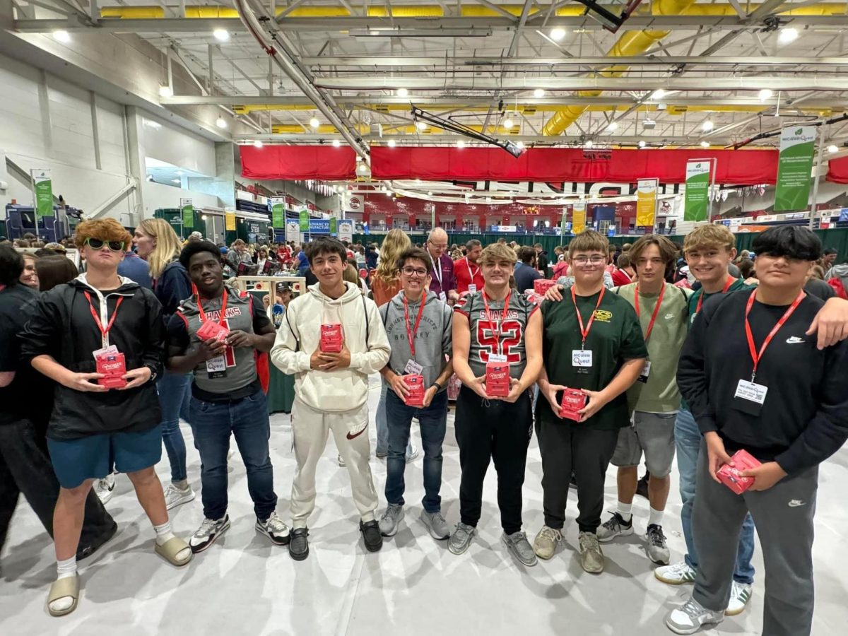 A group of sophomores showcase their Pinoneer Sugar bags at the Pioneer station at SVSU.