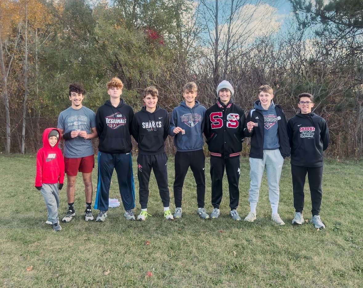 The boys cross country team poses for a photo after a day of racing.