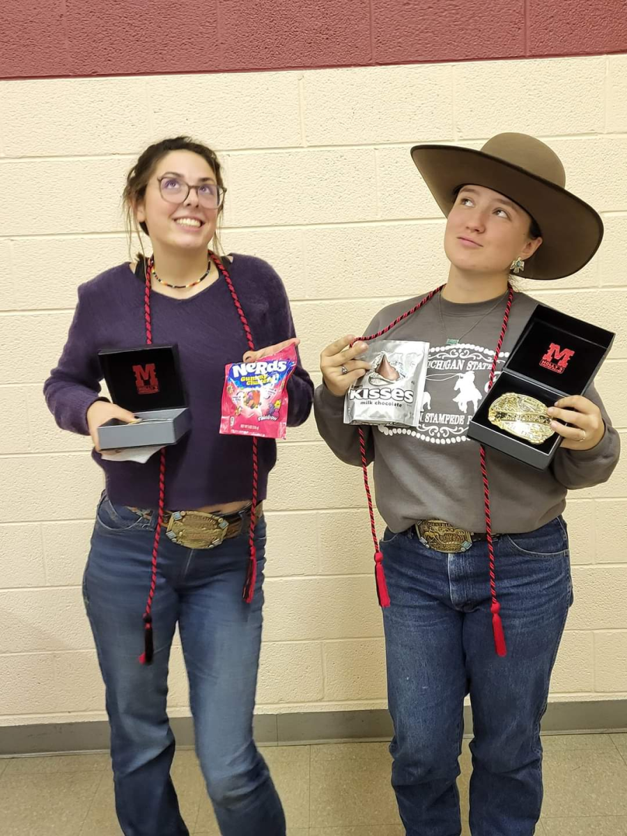 Seniors Bethany Bowerman and Rebekah Ross showcase their medals that they achieved.