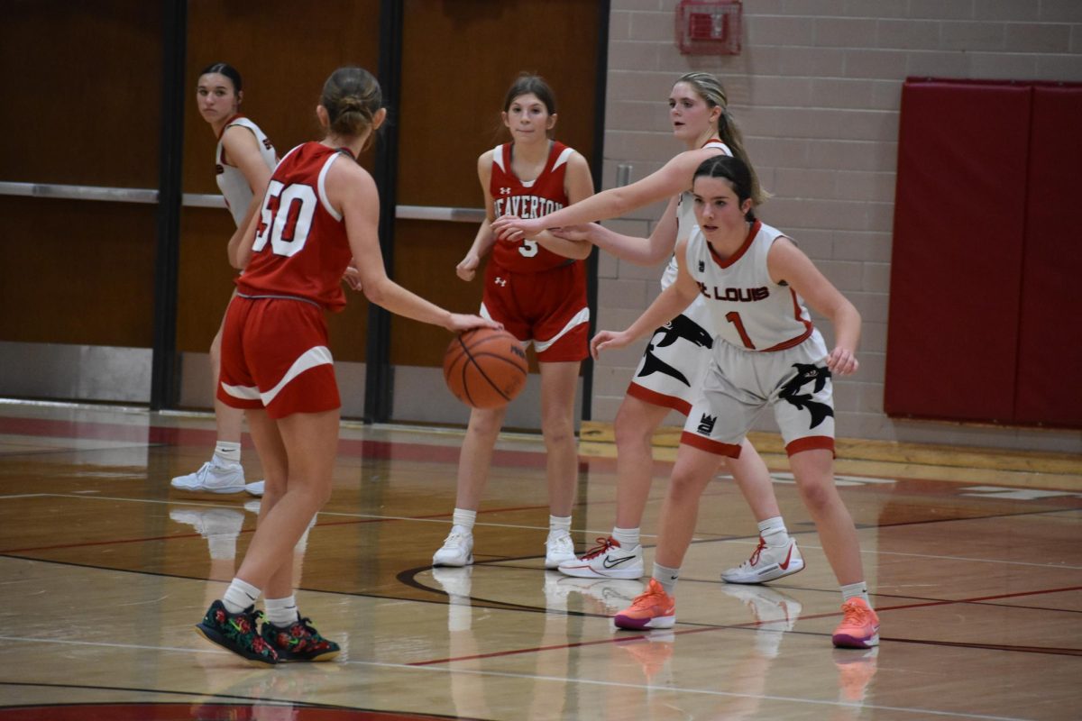 Junior Halle Hoyt plays defense against Beaverton, ready to get a steal.