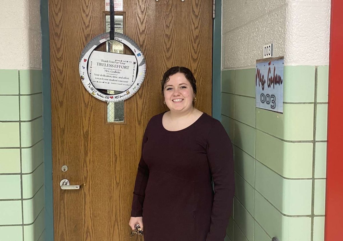 Mrs. Godwin stands proudly with her award displayed on her classroom door.