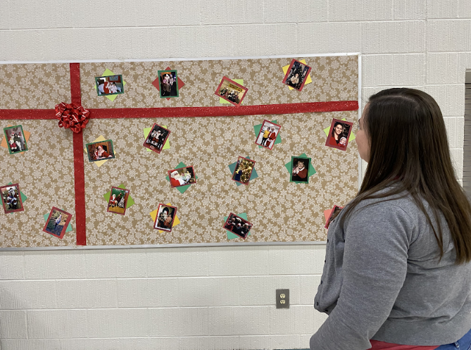 Mrs. Kisser takes a look at the festive board of holiday throwback photos in the cafeteria!