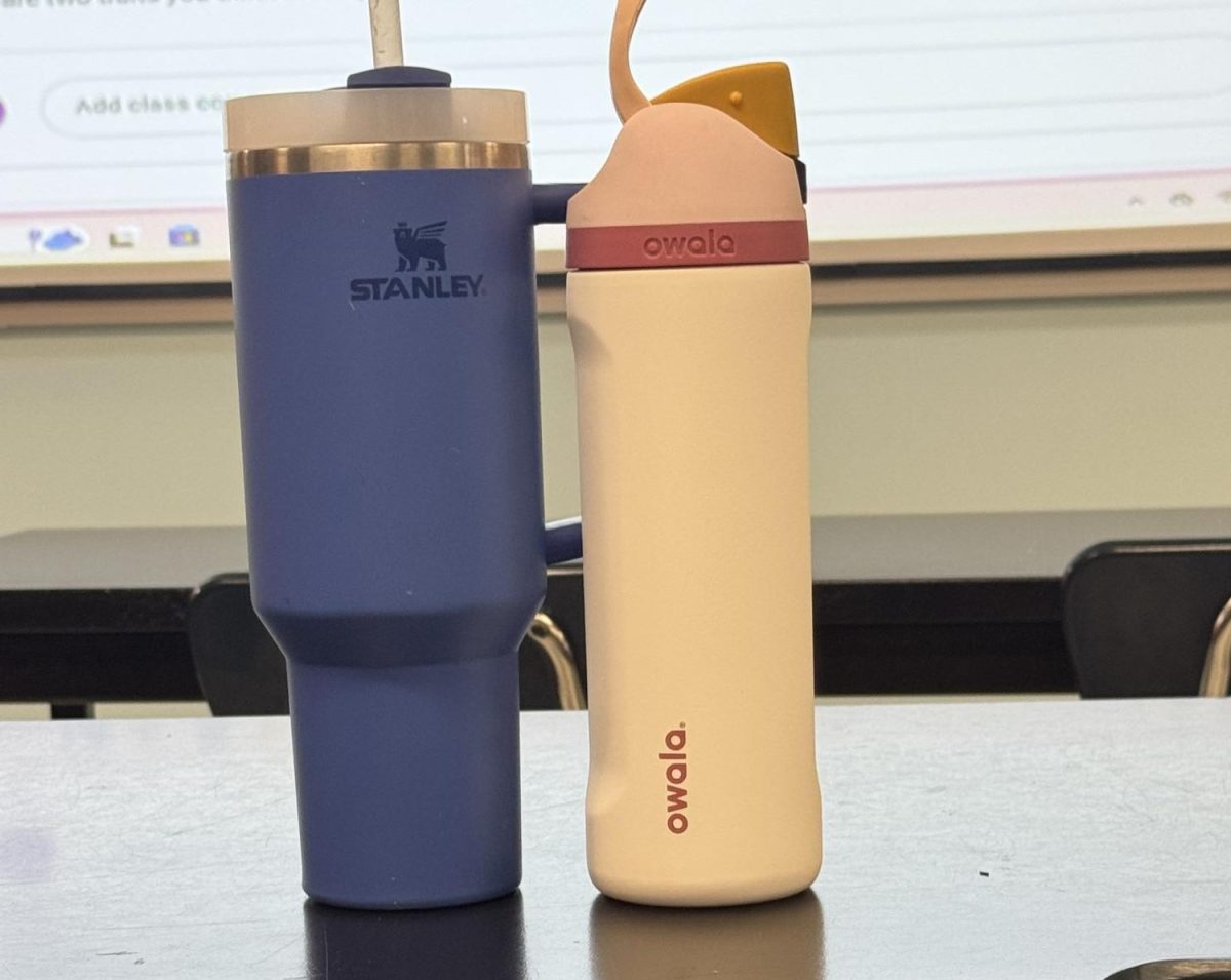 Two students compare their choice of water bottle.