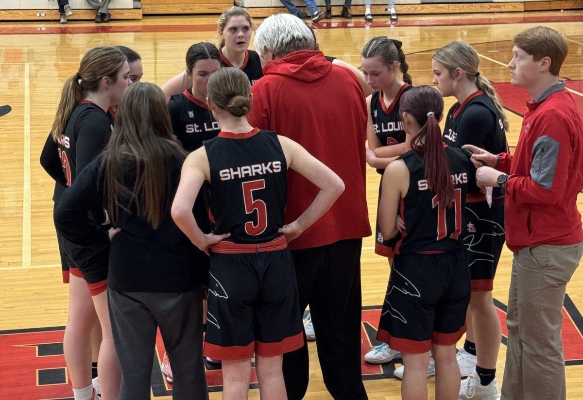 The girls huddle together to strategize their next plays in hopes of winning the game.