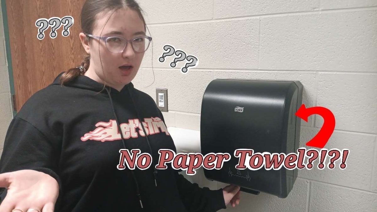 Junior Gracie Lombard stands perplexed at the absence of paper towels. 