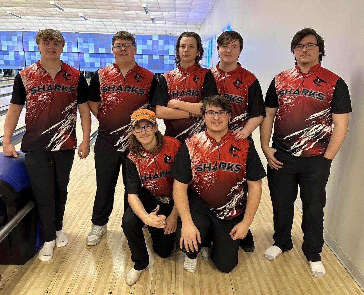 The boys varsity bowling team takes a photo together after their match.