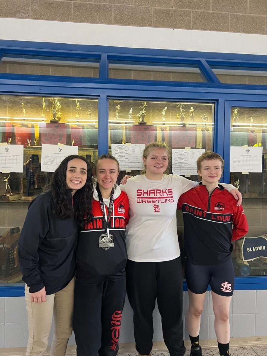 The girls wrestlers take a photo after a successful day of wrestling.