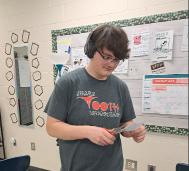 Senior Damian Rosenberger listens to music while working.