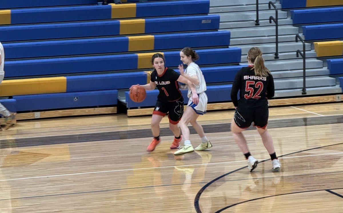 Junior Halle Hoyt dribbles the ball around Harrison's defense, looking for a pass to score.