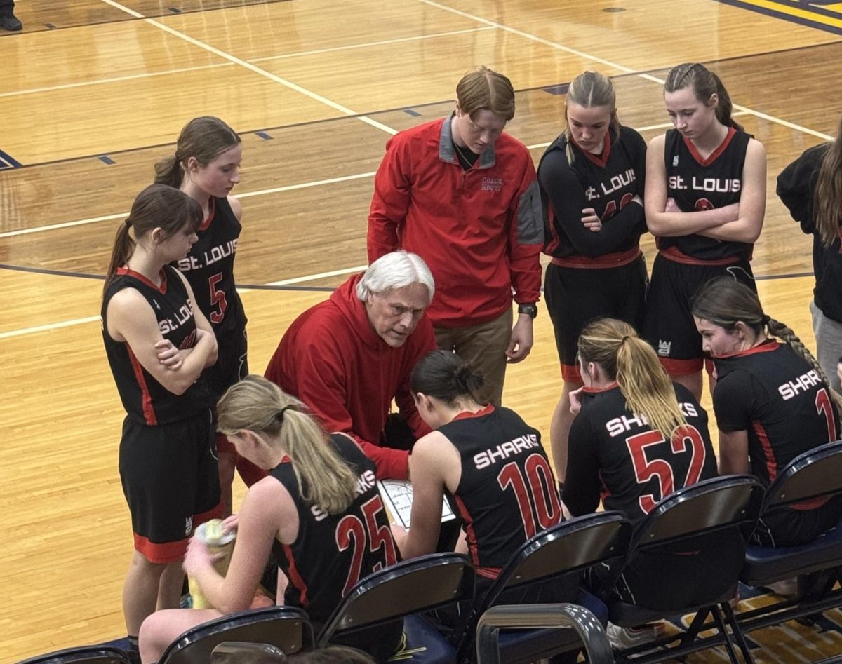 The girls team reconvenes during a time out. 