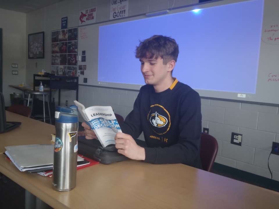 Senior Landon Pestrue studies and reads a book.