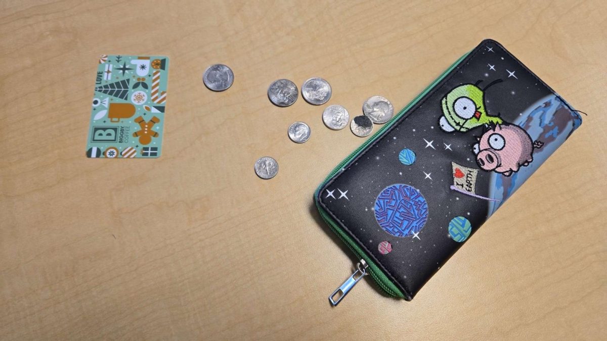 The display of money spread across the desk with a card