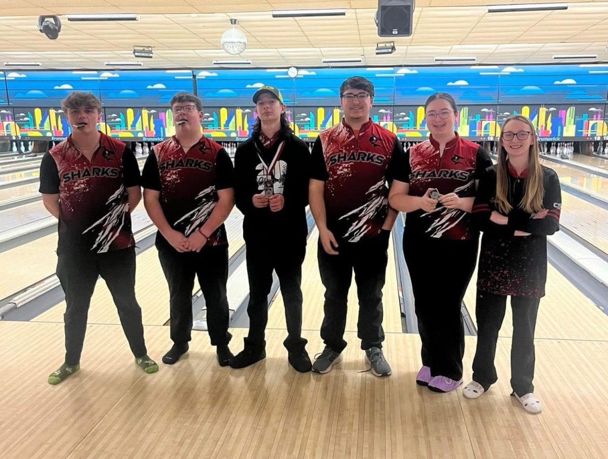 The bowlers receiving all-conference awards take a photo with their medals. 