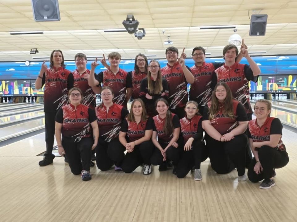 The girls and boys varsity bowling teams take a photo after the regional competition. 