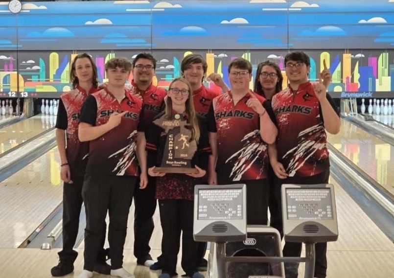 The boys team takes a photo with the trophy they claimed for winning the regional competition.