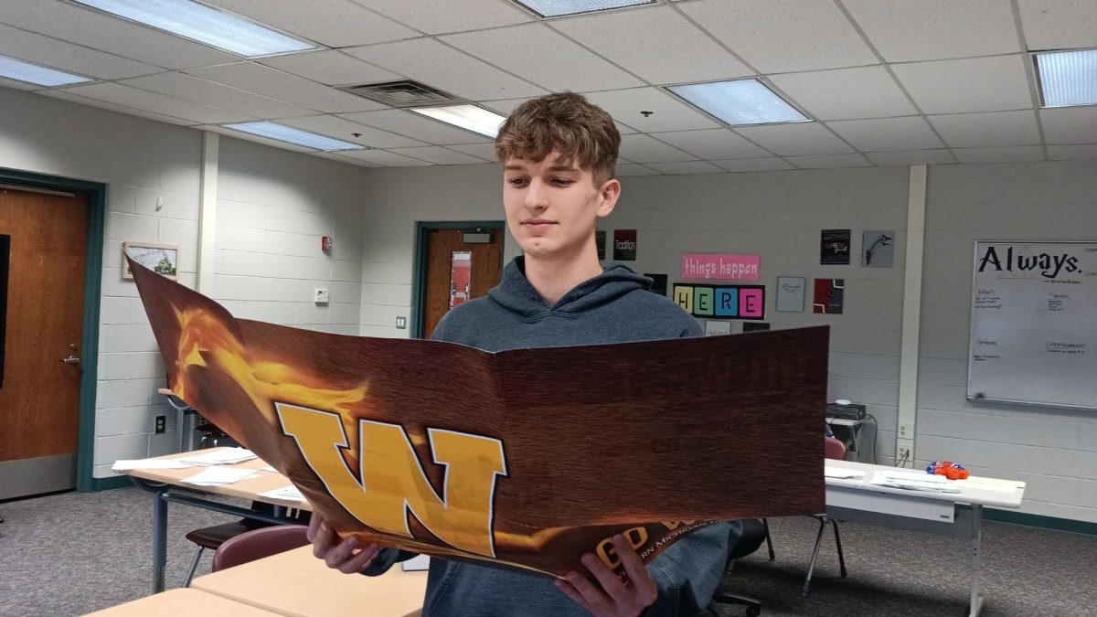 Senior Landon Pestrue looks over a pamphlet for Western Michigan University.