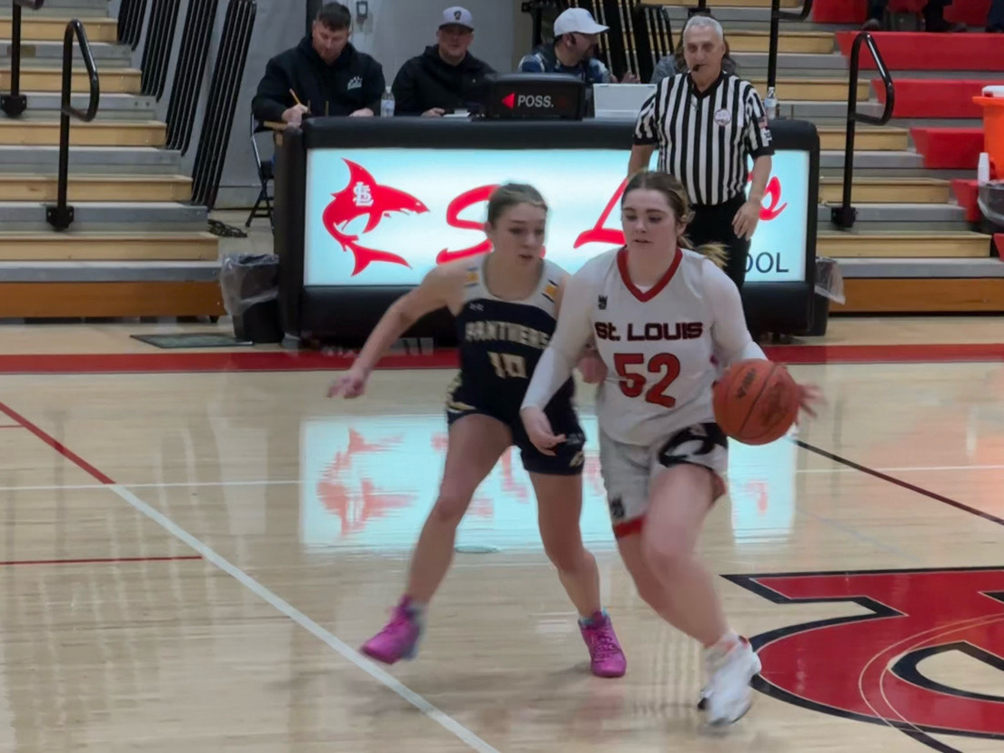 Senior Zoey Clarke dribbles down the court past Standish Sterling's defense. 