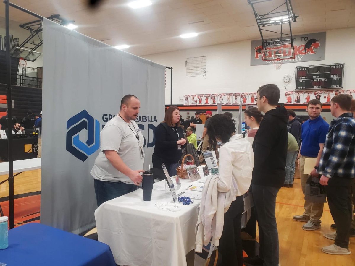 Two SLHS students converse with one of the many businesses at the career fair. 