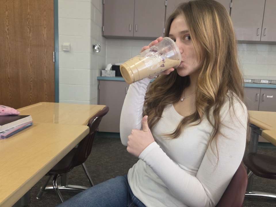 Junior Izabelle Stiffler drinks her preferred drink from Starbucks.