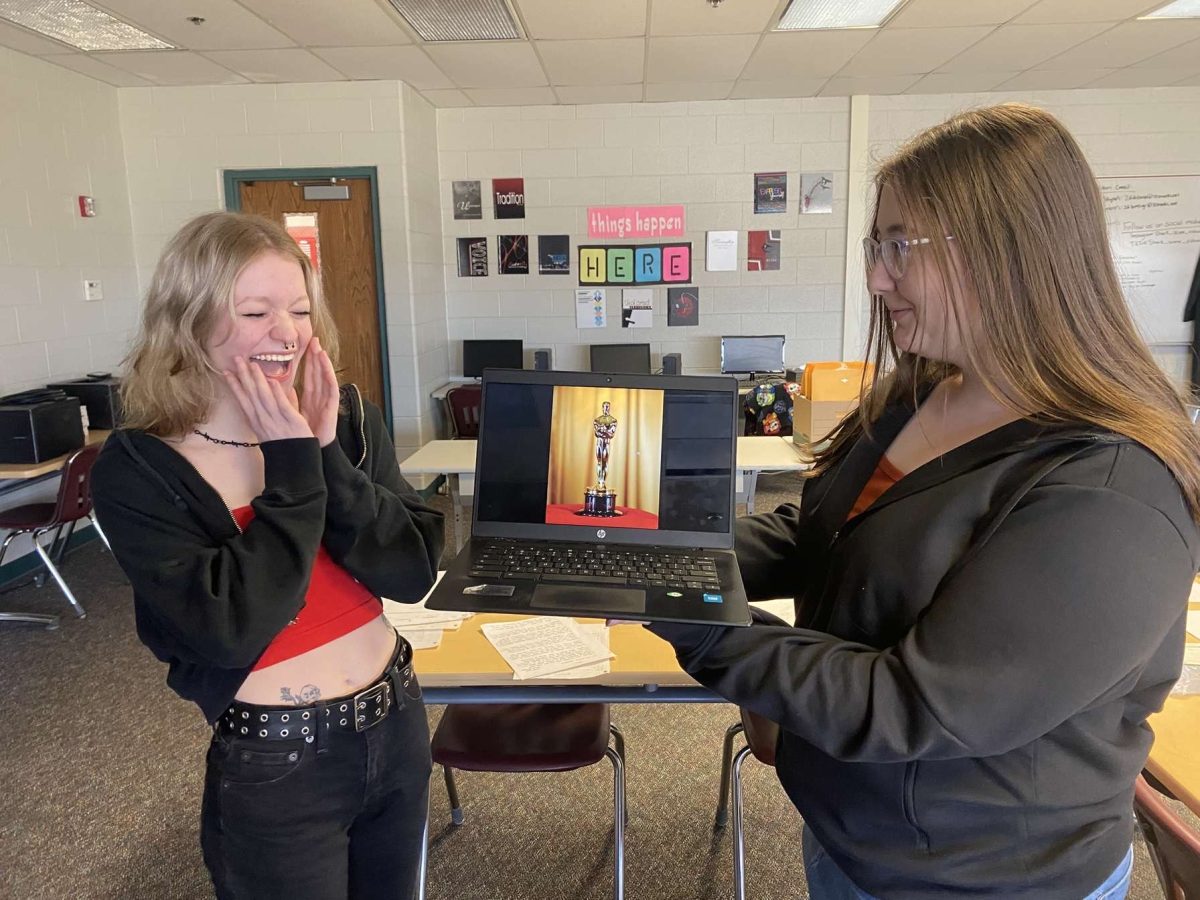 Junior Gracie Lombard presents senior Reese Horton with an Oscar award.