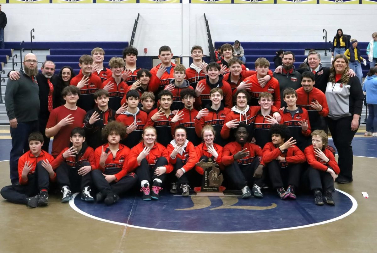 The wrestling team poses together in the regular season of wrestling.