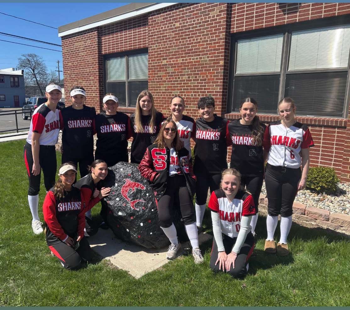 The softball team takes a photo together before the game.