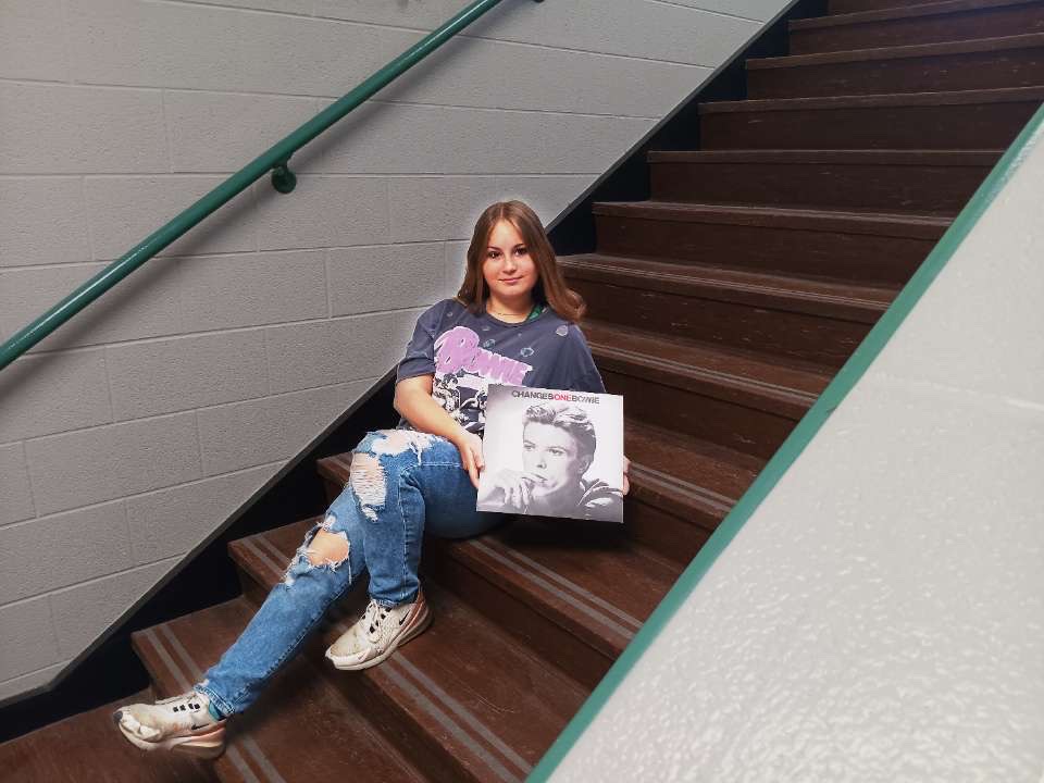 Junior Devine Francisco poses with a David Bowie album in hand. 