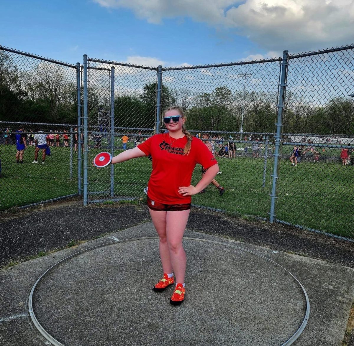 Tess Farkas takes a photo in the discus ring.