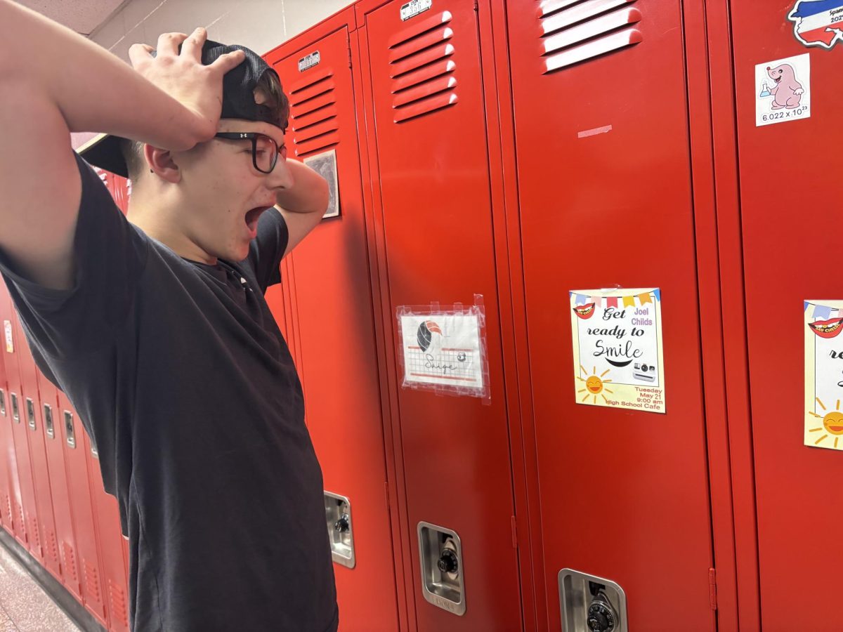 Junior Joel Childs stands in shock as he finds out he won an award.
