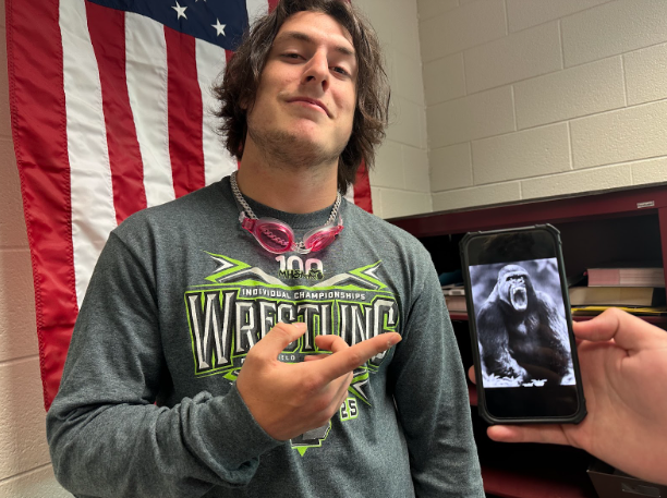 A confident Maddox Cline poses next to a gorilla he is sure would lose to 100 men.