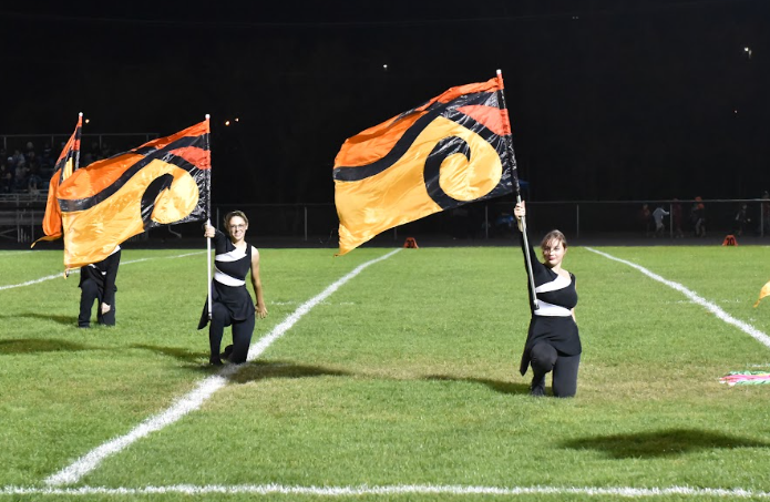 Two band seniors perform for the color guard in marching band, their last season in the SLHS band.